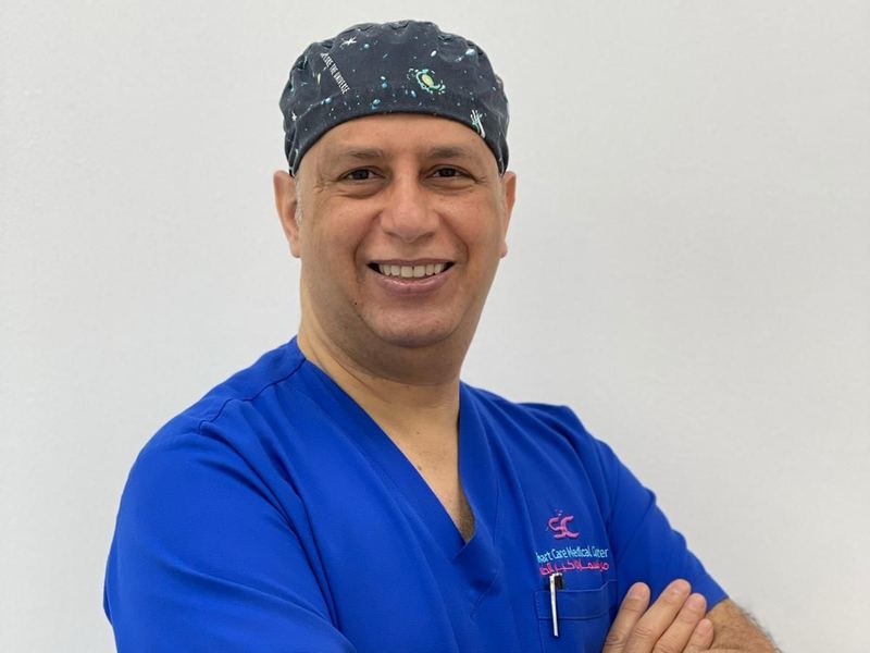 Dr. Mohamed Hussein in surgical scrubs and cap