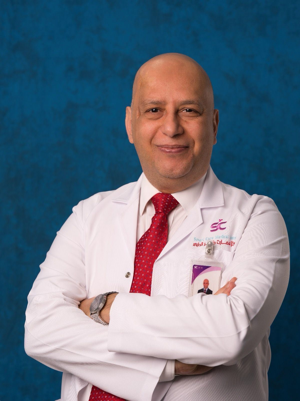 Dr. Mohamed Hussein, in a white coat with a Smart Care Medical Center badge