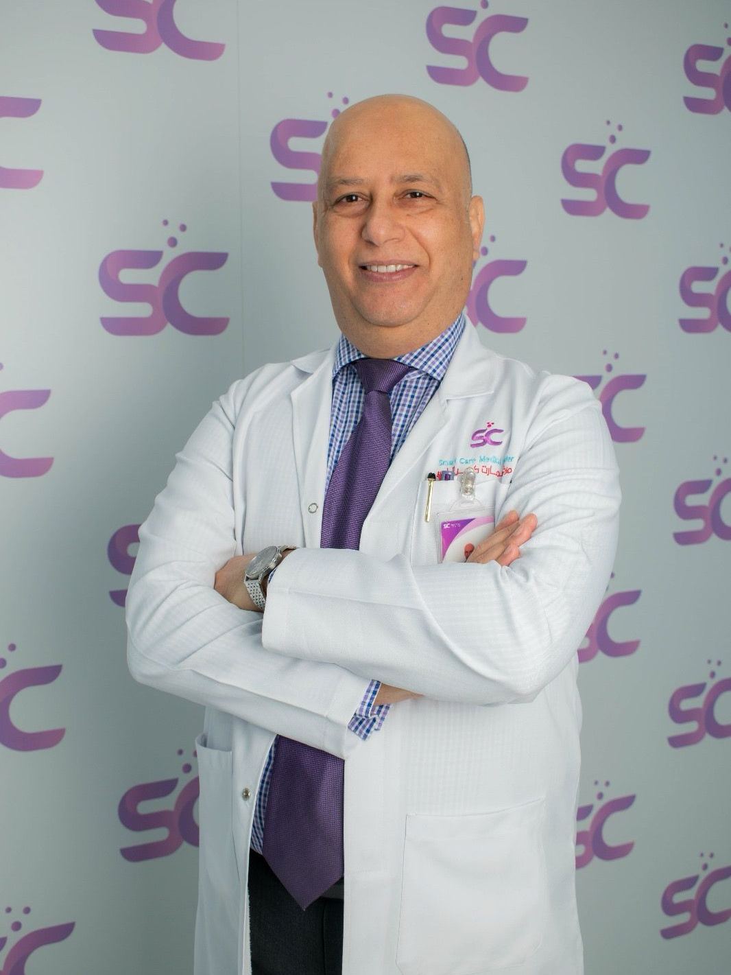 Dr. Mohamed Hussein in a white coat at Smart Care Medical Center, Manama
